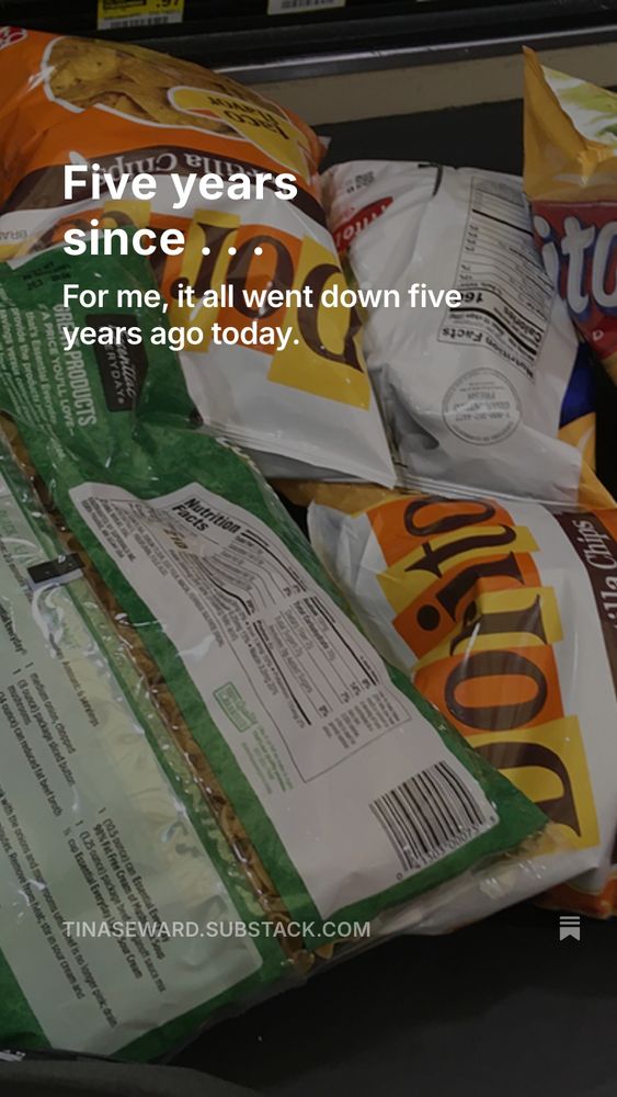 A pile of Doritos, Fritos, and a bag of split peas at a grocery checkout.