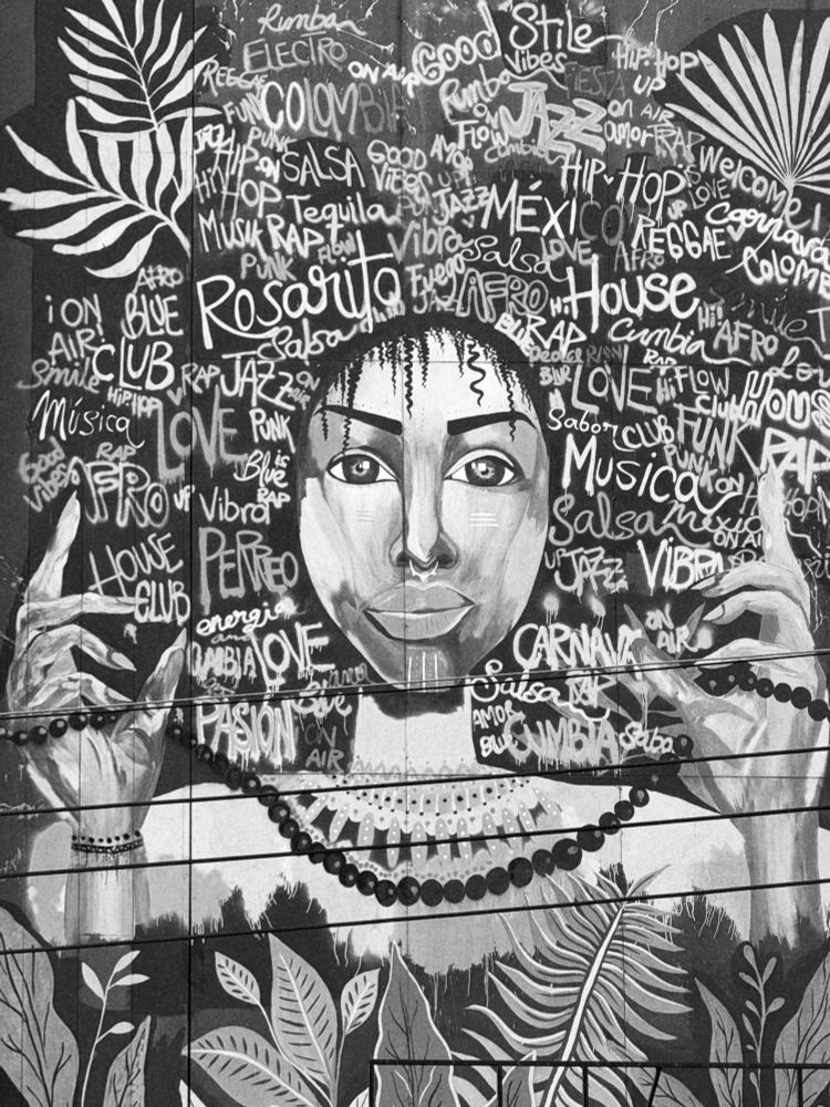 A black and white photo of graffiti depicting an indigenous woman in Bogotá.