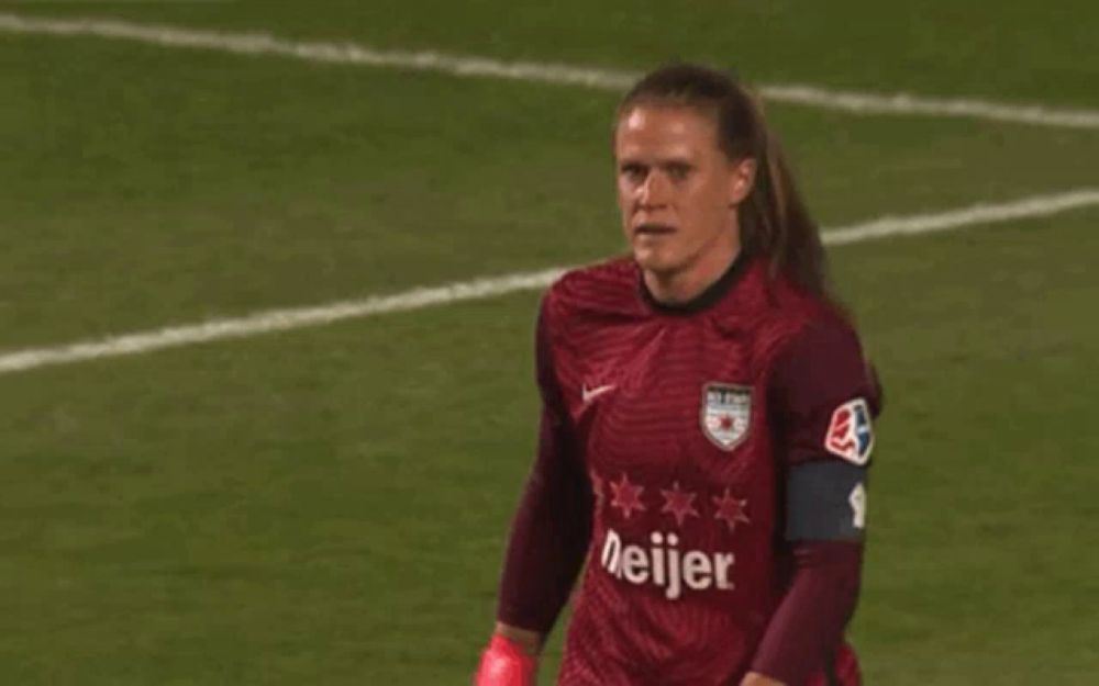 a female soccer player wearing a meijer jersey stands on the field