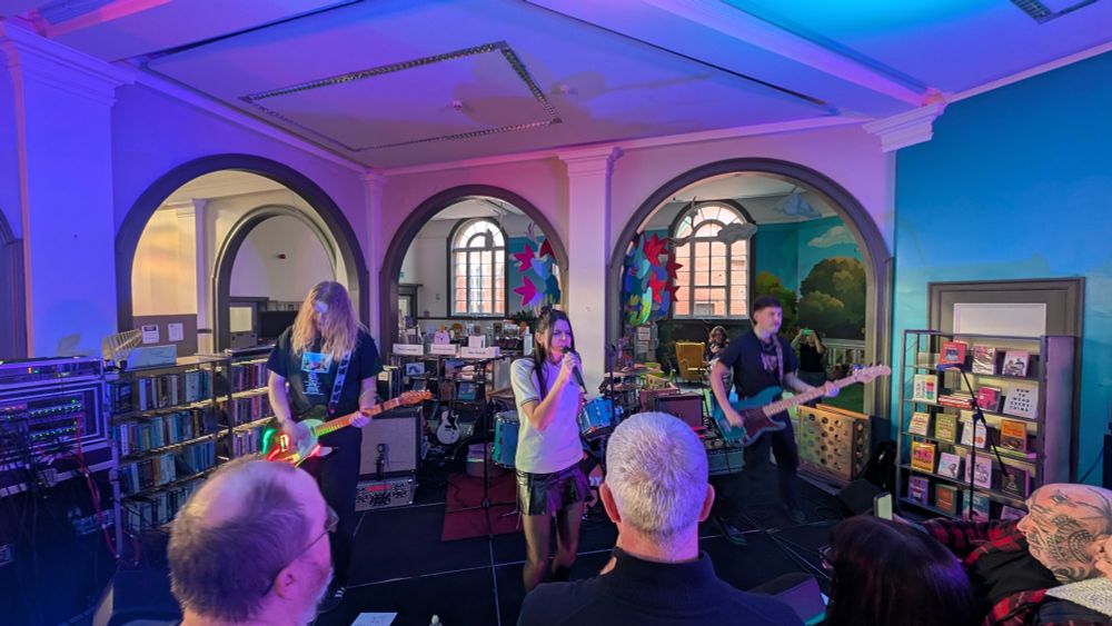 Shot of the whole band from above looking into the library 