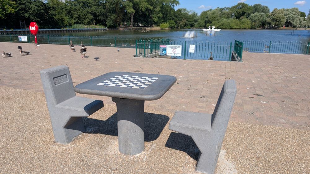 Two concrete seats and a concrete table with a chess board built in. No chess pieces.