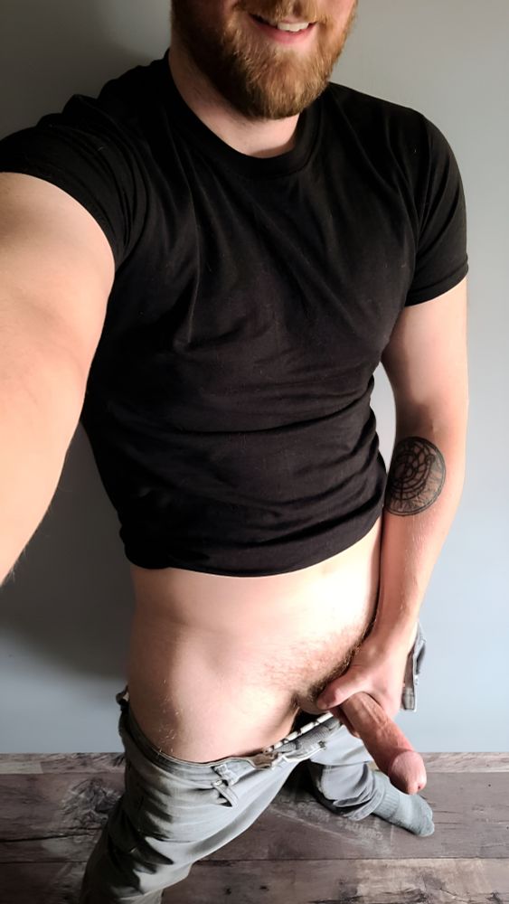 Person with their pants down and a black tshirt pulled up with their hard dick out 