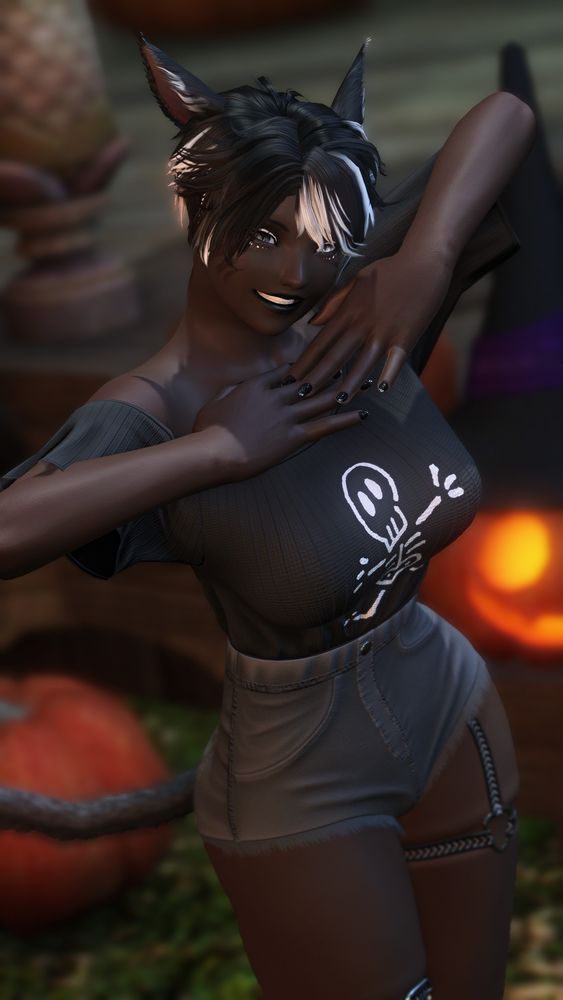 Domino posing for the camera with her arms up and folded to rest her hands under her chin. She is wearing a shirt with a cartoony skeleton drawing and waist-high short shorts.