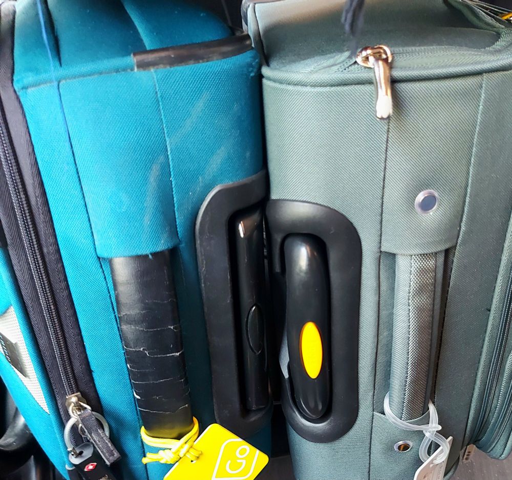 Two full luggage bags, one old and one brand new.