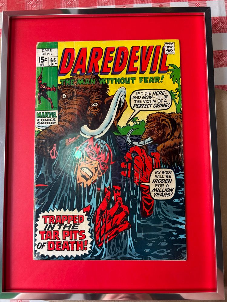A framed Daredevil #66 depicting Daredevil sinking into a tar pit with woolly mammoths, saying “if I die here and now, I’ll be the victim of a perfect crime! My body will be hidden for a million years!”