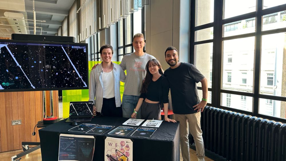 Astronomers posing for the camera with the JWST activity