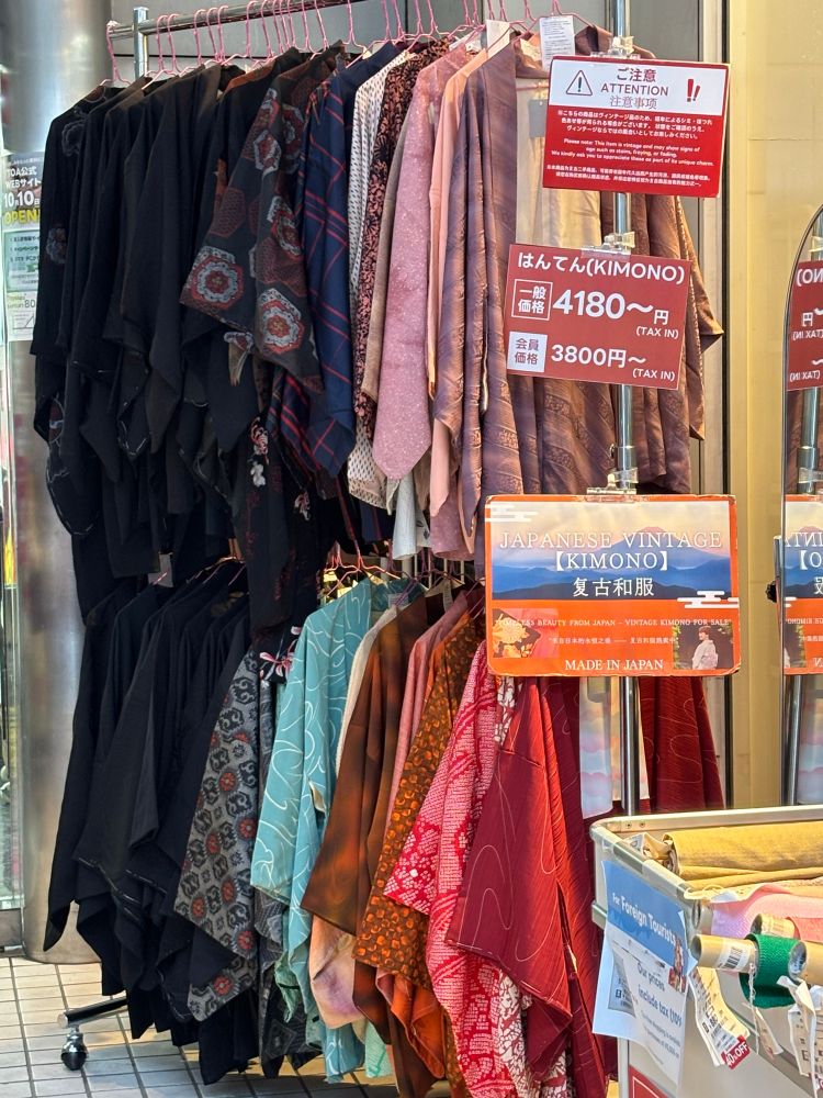 Vintage kimono hang on a rack for sale. 