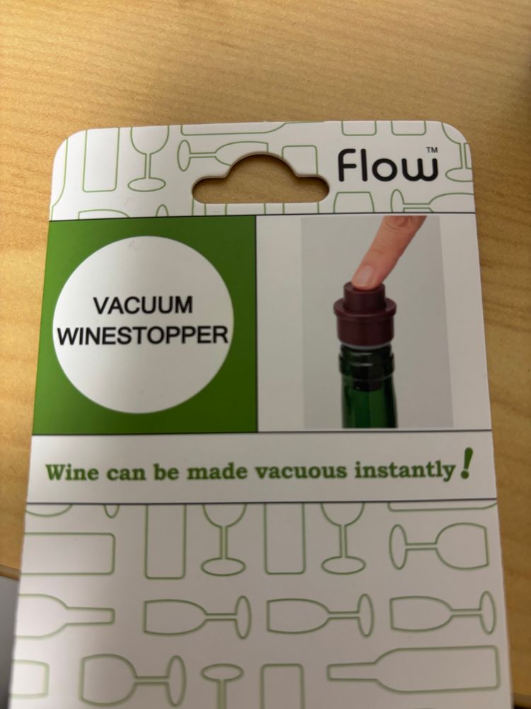 A tag from a Flow brand vacuum wine stopper product. It says “Wine can be made vacuous instantly!”
