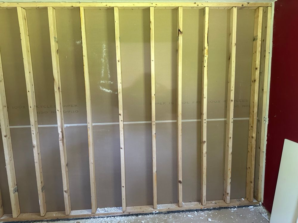 Fully exposed wall studs with the drywall on the other side still fully intact 