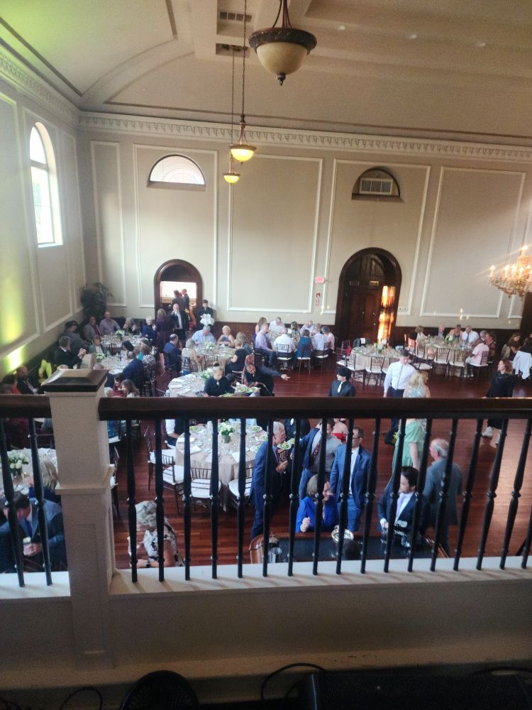 balcony railing overlooking a wedding reception