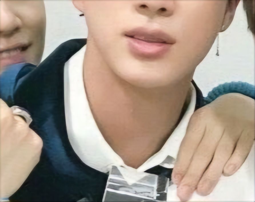 Close up of Jin's lips with Yoongi's hand near his chin from arm put around him