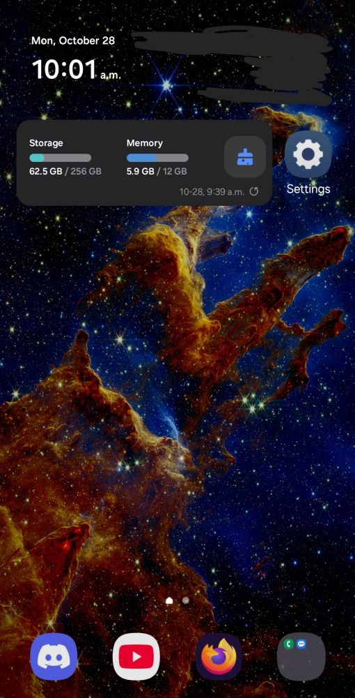 A screenshot of a phone's home screen. The background features the JWST photograph of the Pillars of Creation, part of a nebula featuring distinctive pillars of interstellar gas amongst a starry space.

There are also widgets for time and phone storage and memory, as well as app buttons for Settings, Discord, YouTube, Firefox, and a folder with Phone and Messages.