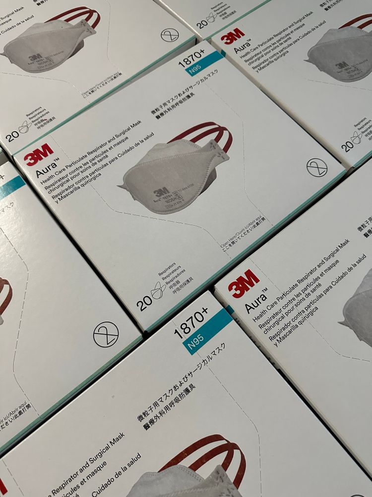 Several boxes of 3M Aura 1870+ respirators.