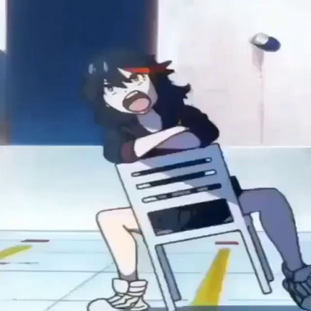 a girl is sitting on a chair with her mouth open and screaming .