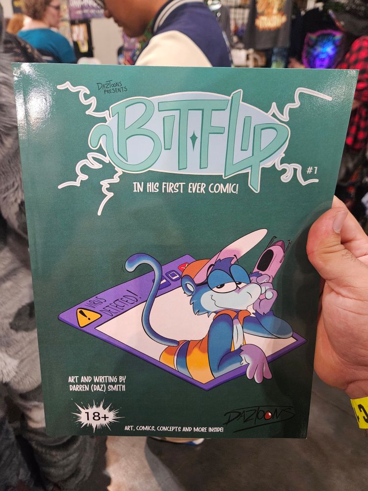 Photograph of a comic book with the title Bitflip, showcases a blue anthro primate computer program