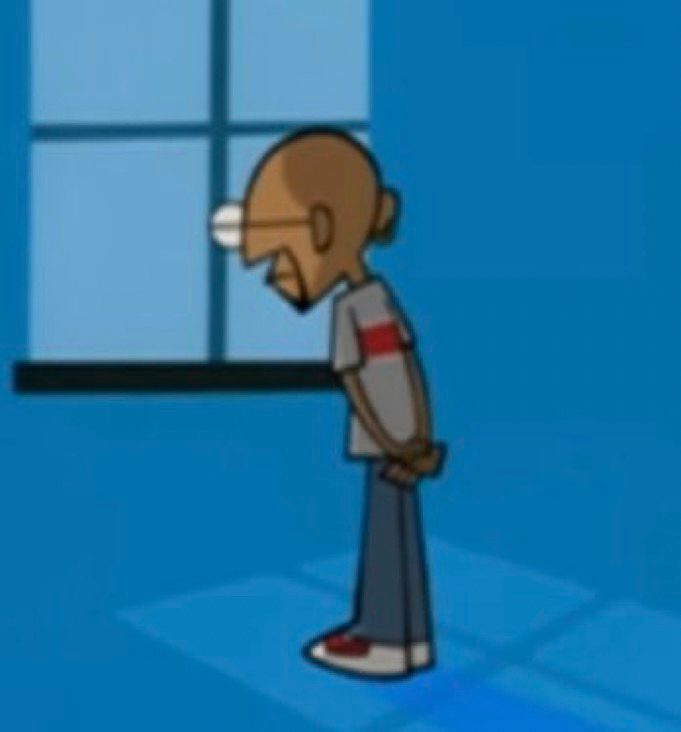 A man looking solemnly out of a window