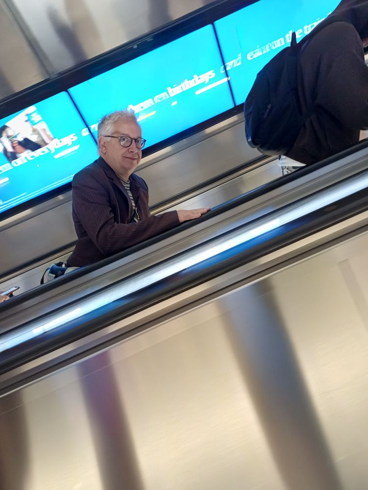 Same man same escalator looking at me but that's OK because we're together.