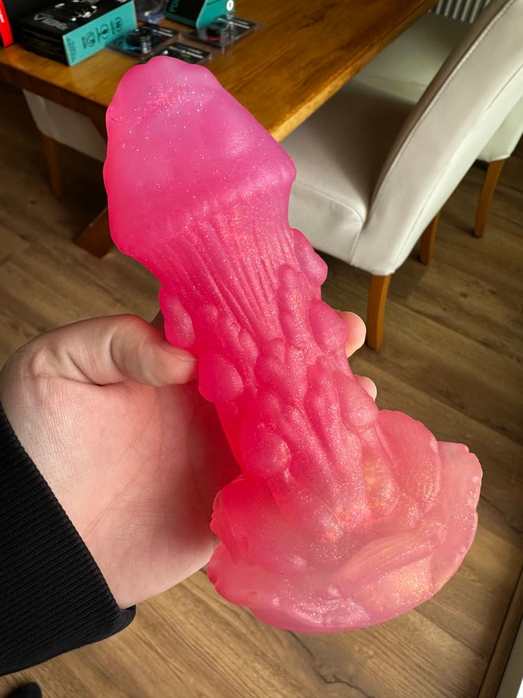 Photo of small pink Amanita dildo by Fantasy Grove in the left hand of Sydney Screams