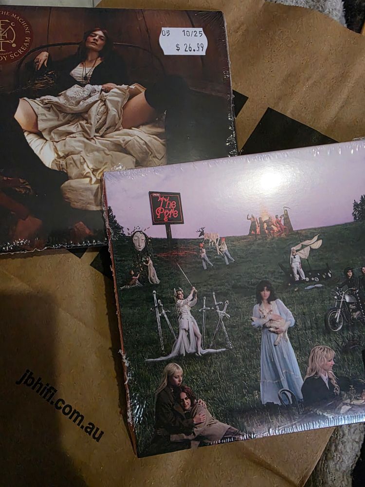 a photo featuring two shrink-wrapped cds, everybody scream by Florence + The Machine and The Pyre by The Last Dinner Party, which are both cardboard cd cases instead of jewel cases