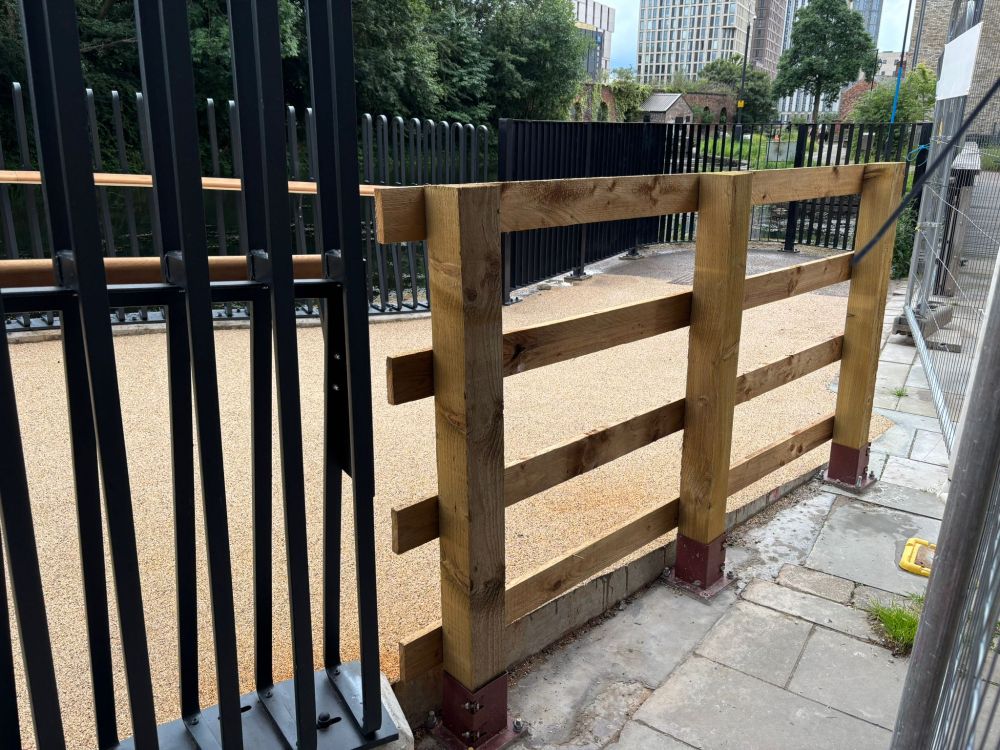 A ramp at the end of the Ashton Canal bridge - a temporary piece of fencing sticks out like a sore thumb