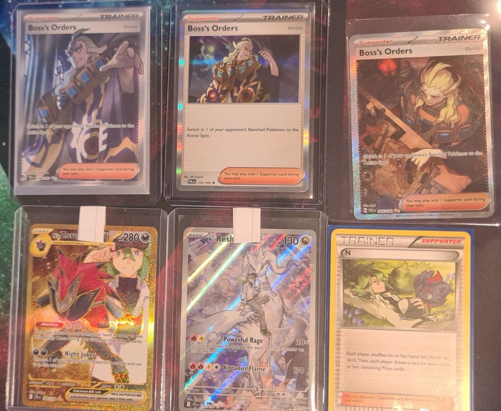 Six pokemon cards
The first three are called "Boss's Orders", and depict the character Ghetsis from Pokemon Generation 5, Black and White / Black 2 and White 2.
The last three are all cards featuring the character N from Pokemon Generation 5.
