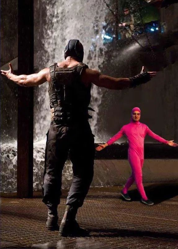 An old meme that shows Bane from Batman with his arms stretched out. There is another person in a pink body suit a distance away with their arms stretched out too as if to challenge Bane even though they are smaller than him.