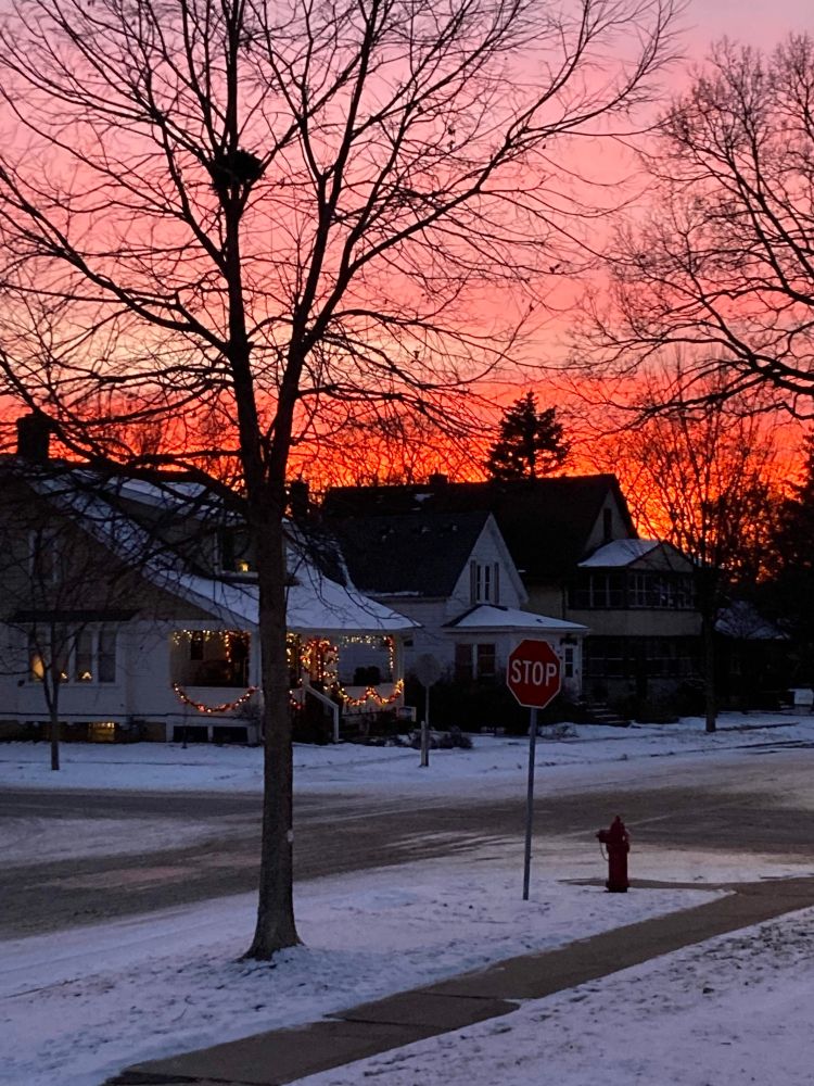 Beautiful layers of pink/orange/white forming a sunset visible in St. Paul, Minnesota (well, not now; it's very fleeting).