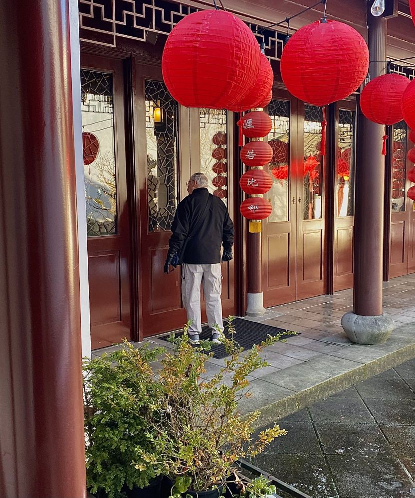 My grandpa peers into the doorway of a space in the Dr. Sun Yat-Sen Classical Chinese Garden.