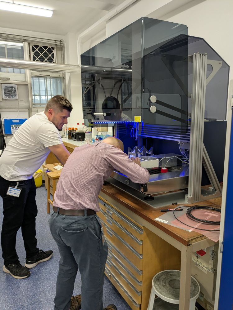 Two Bruker engineers installing the cooling rack on the SamplePro Tube liquid handler