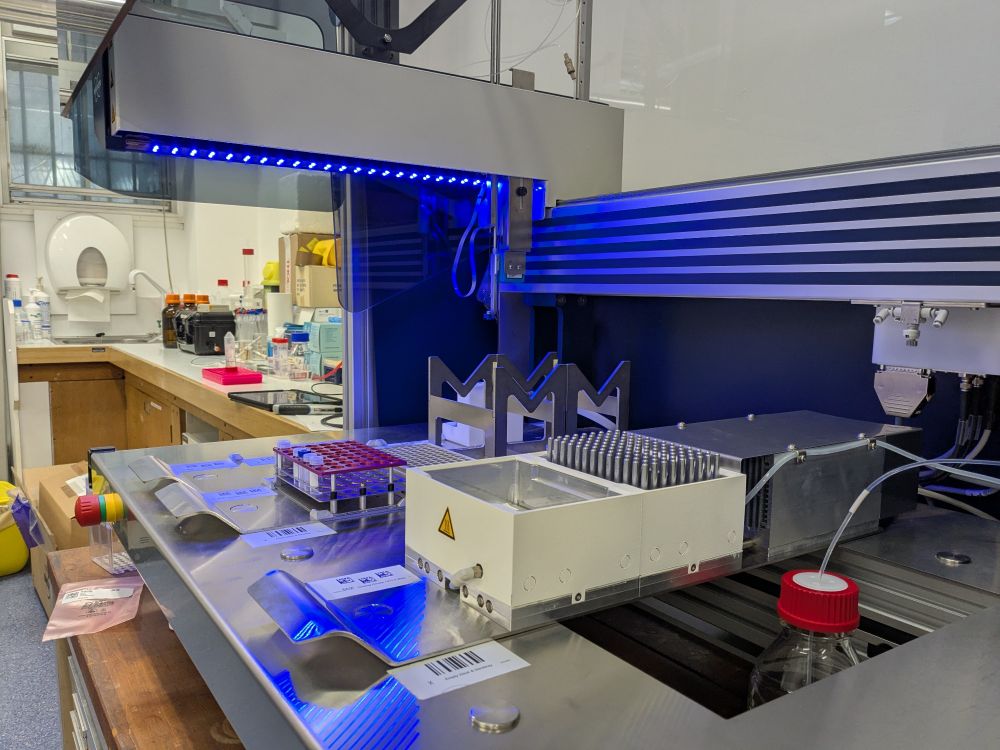 Bruker SamplePro Tube liquid handler with the new cooling rack installed. The cover is open and the robot is lit by a blue LED strip.