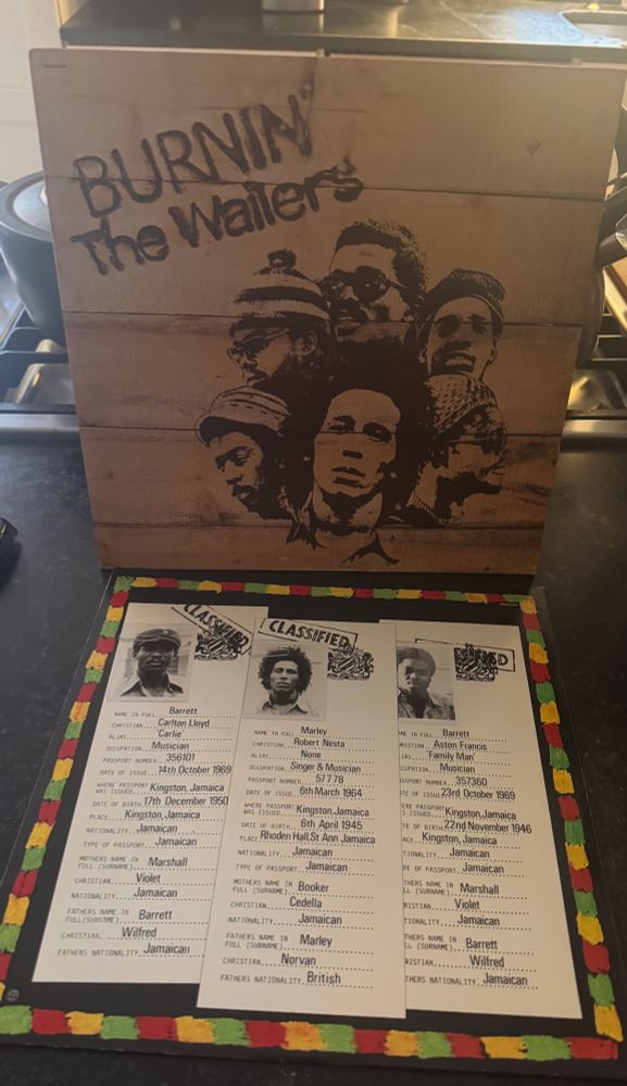 Front cover of Burnin’ by The Wailers standing upright, and one side of the sleeve laying down on front of it 