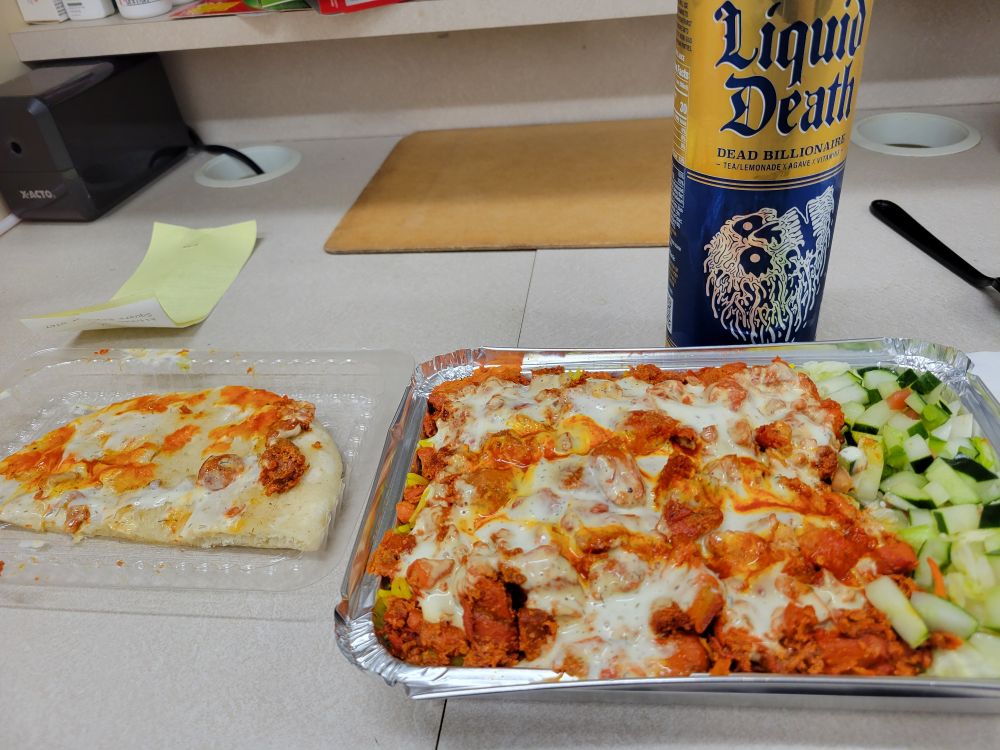 Chicken over rice with white & red sauce, pita bread and an LD