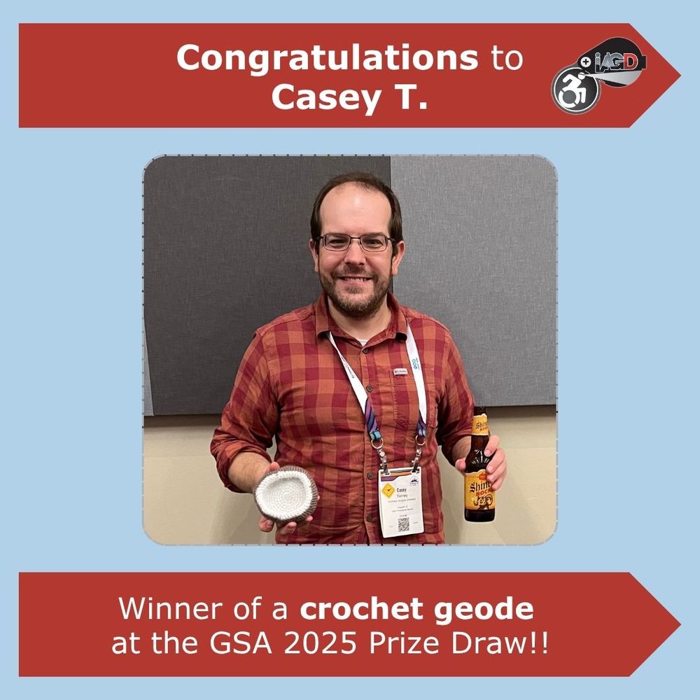 
Graphic featuring a picture of a person smiling at the camera and holding a crochet geode with a white inside. The text reads:

Congratulations to Casey T. Winner of a crochet geode at the GSA 2025 Prize Draw!!