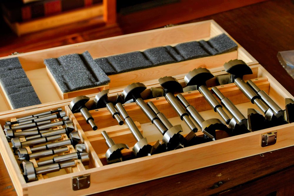 A boxed set of woodworking Forstner bits.