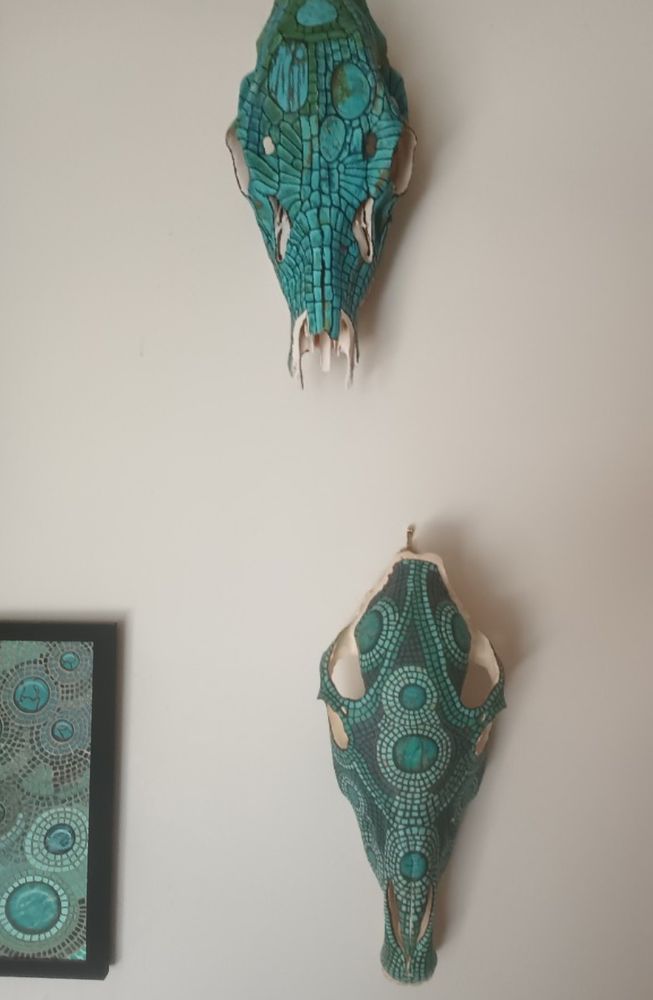 Top, goat skull. Below, donkey skull. Both painted to resemble turquoise mosaic. 