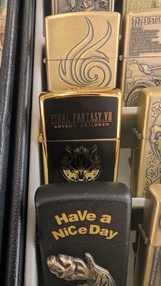 A gold lighter with the Final Fantasy VII: Advent Children logo