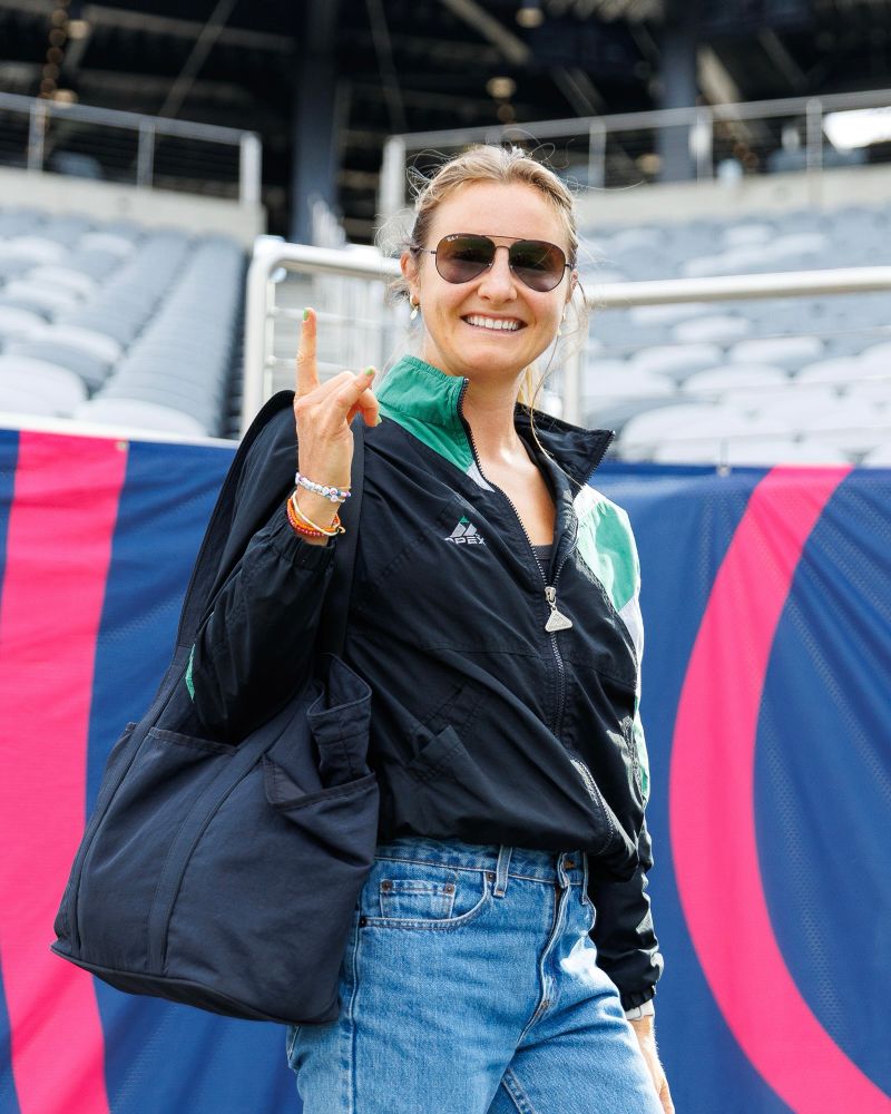 Kyra Carusa smiling during arrivals.