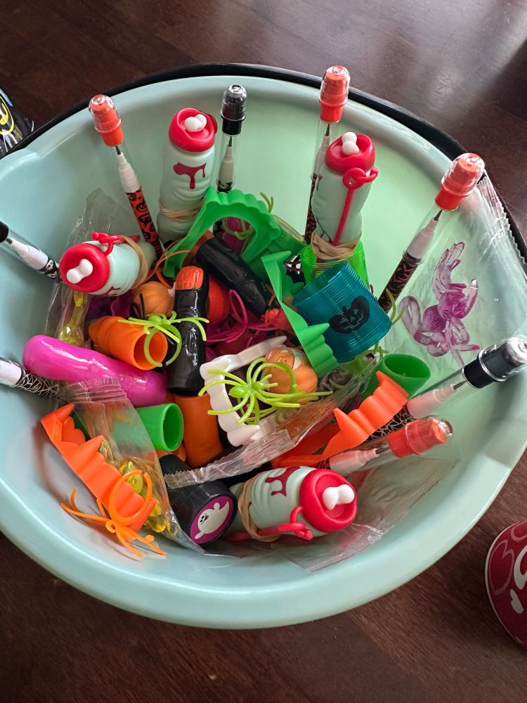 Plastic Halloween toys inside a Teal Pumpkin 