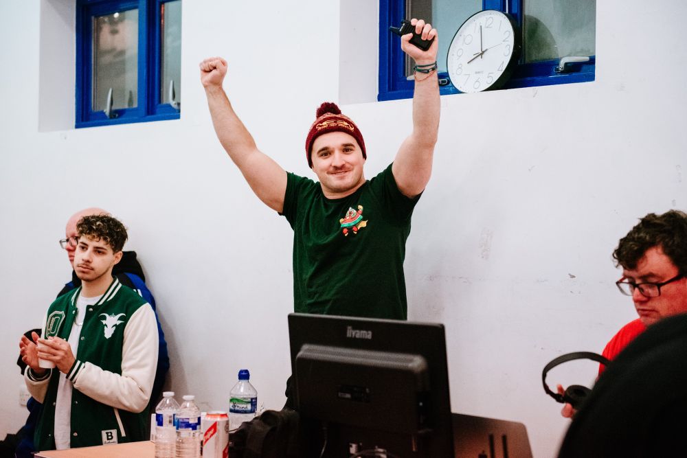 Referee Tom Scarborough, wearing a Green Ceasefire T Shirt, holds his hands up in triumph about 2 hours before being assaulted again and striking with the rest of the officials.