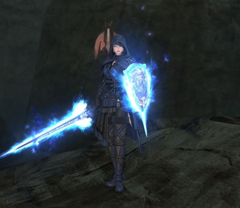 A miqote paladin standing with a blue flamed sword and shield. 