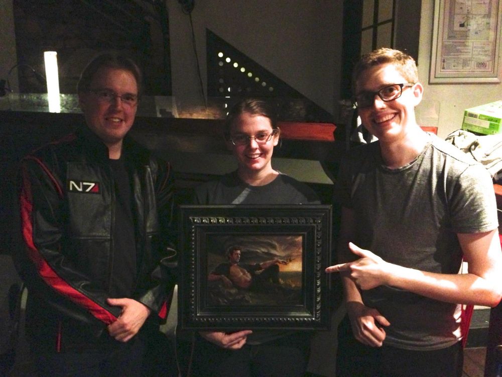 Three friends posing with the photo at a bar an improv show.