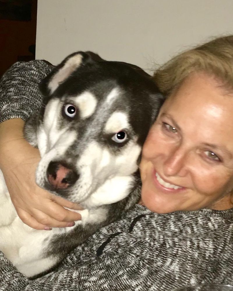 Me hugging and loving on my girl SALMA- rescued husky/lab mix with a labs body and husky coloring including blue eyes. Her name stands for Somebody Actually Loves Me A lot!