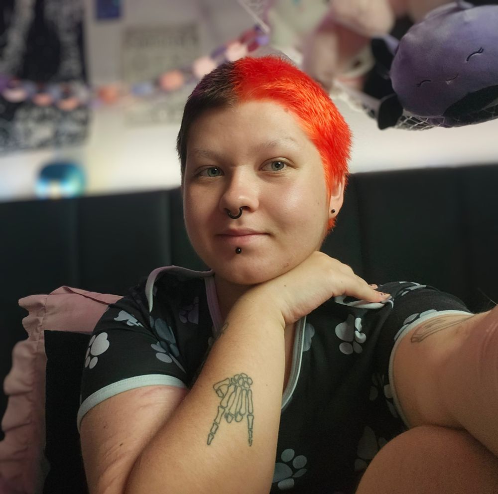 Bat takes a selfie with his new split dyed hair, orange on one side & its natural brown on the other.
