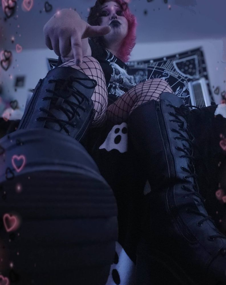 Bat wearing platform boots, sitting on his bed & silently commanding they be cleaned.
