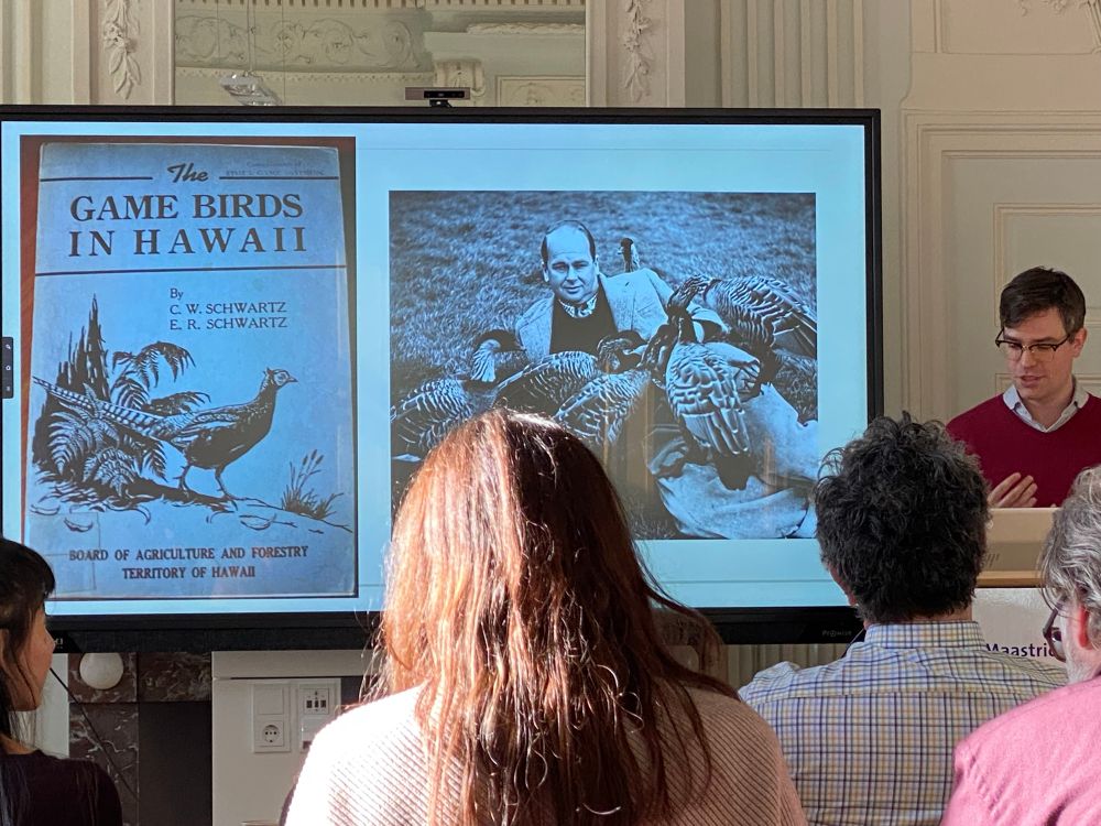 Vincent Bijman speaking about the mongoose. Image of a book on game birds in Hawaii and a scientist surrounded by game birds.