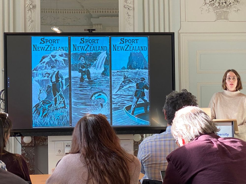 Vanessa Bateman speaking on wapiti (or elk) in New Zealand. Three images show magazine covers depicting New Zealand sport hunters and fishers.