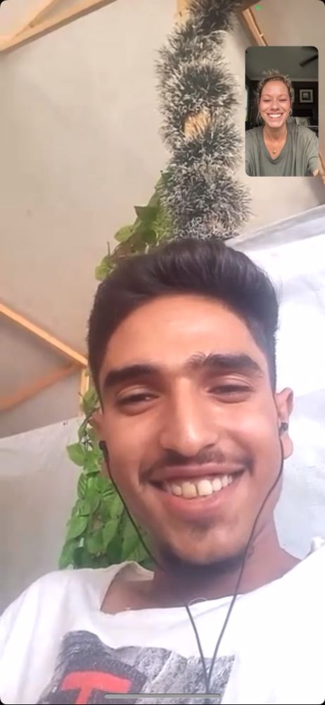 A screenshot of Casey on a WhatsApp video call with Mohammed. Both are smiling. 