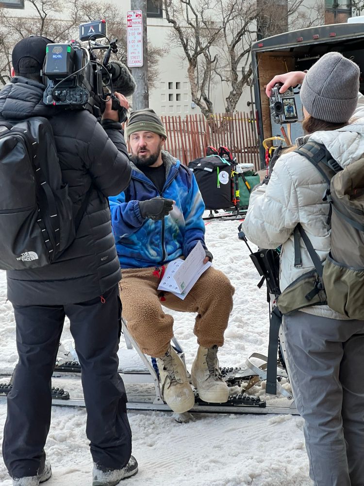 Musher Quince Mountain sits on his sled and gives an interview at the ceremonial start of the Iditarod in Anchorage. 