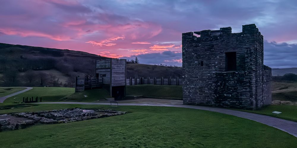 A pink sunrise behind replica section of Hadrian’s Wall at Vindolanda. 