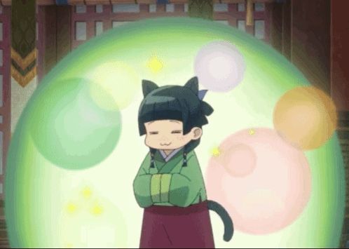 a girl with cat ears is standing in front of a green ball